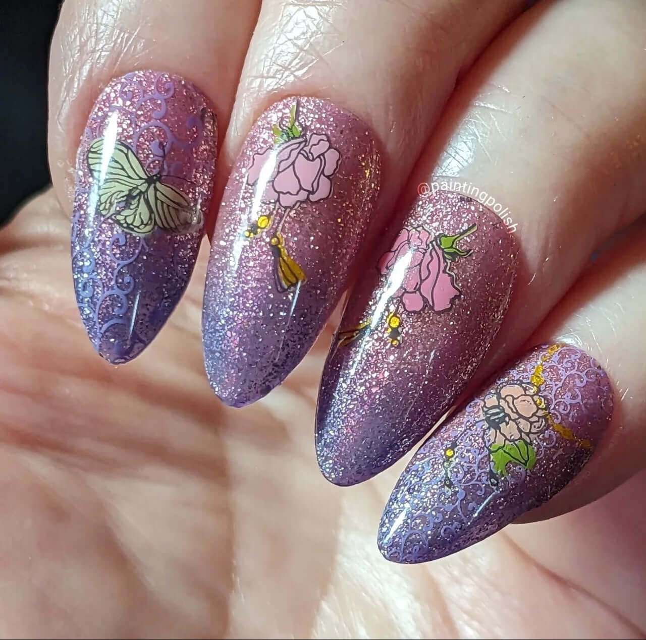 shimmery-ombre-manciure-with-nail-art-designs-of-a-butterfly-and-flowers-with-tassels