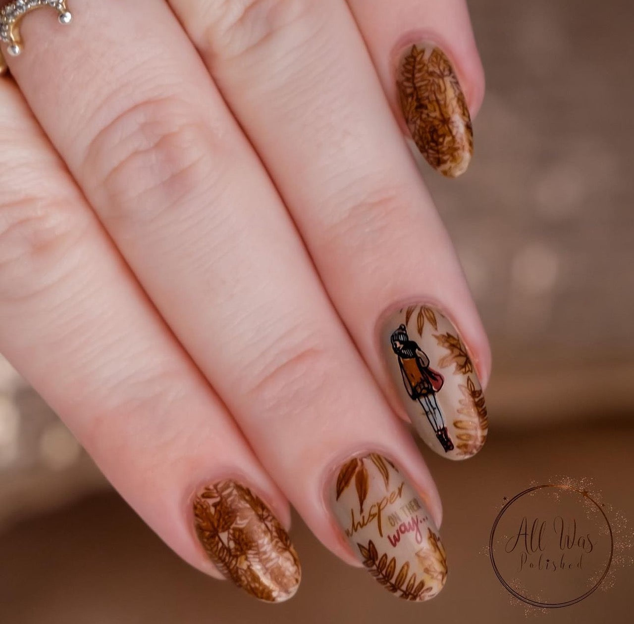 beautiful-manicure-with-nail-art-designs-of-autumn-leaves-a-girl-in-hat-andscarf-and-the-words-whisper-on-their-way