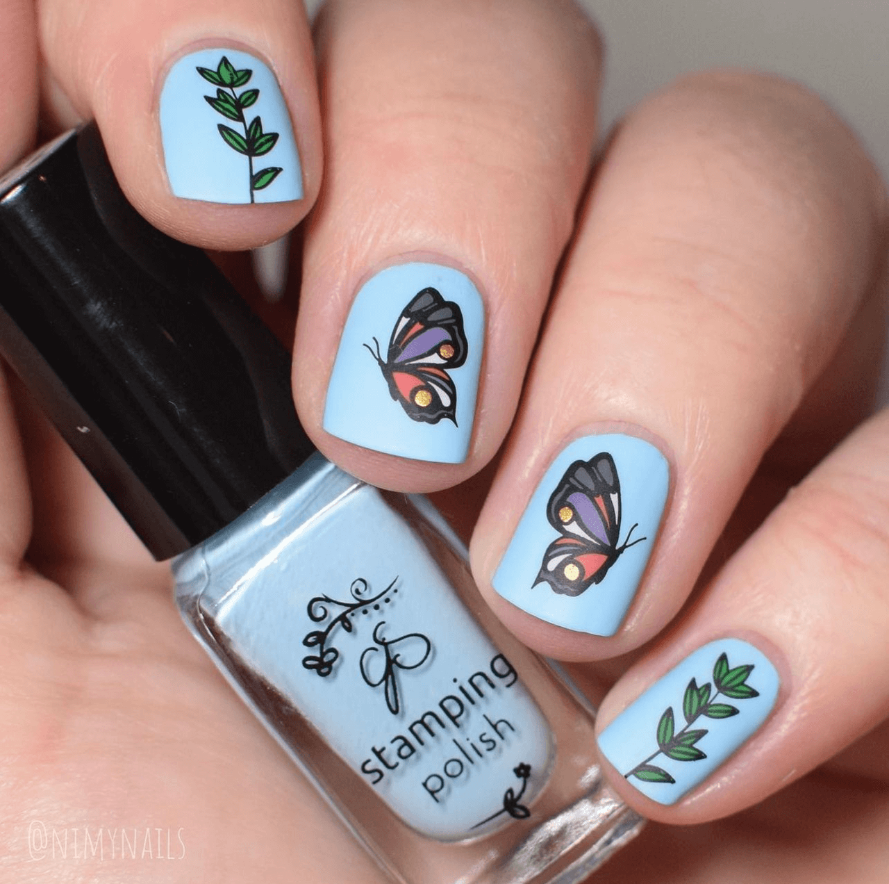 striking-manciure-with-layered-nail-art-designs-of-two-butterflies-and-leaves