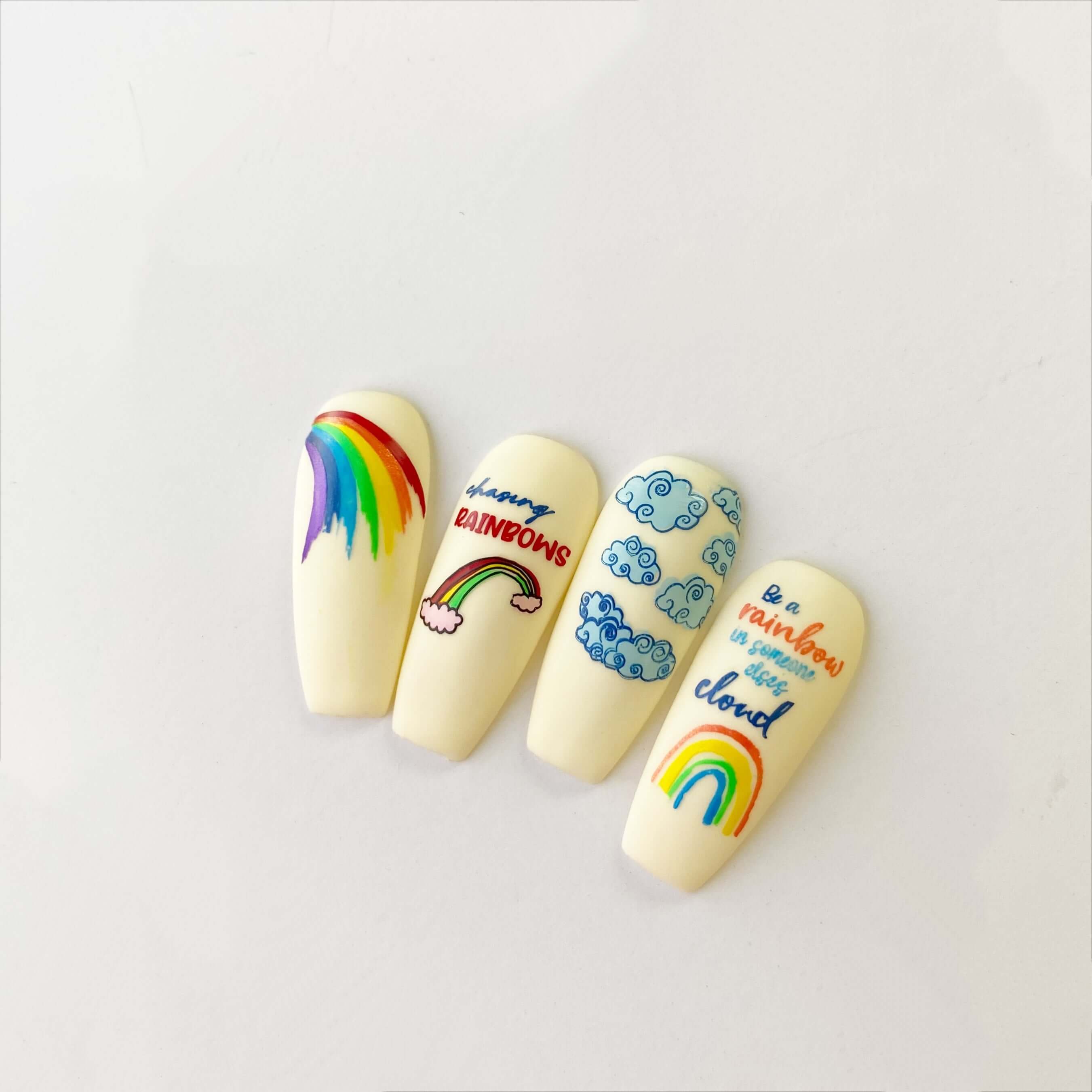 nail-tips-showing-nail-art-designs-of-rainbows-and-cluds-with-nail-art-words-be-a-rainbow-in-someone-elses-cloud