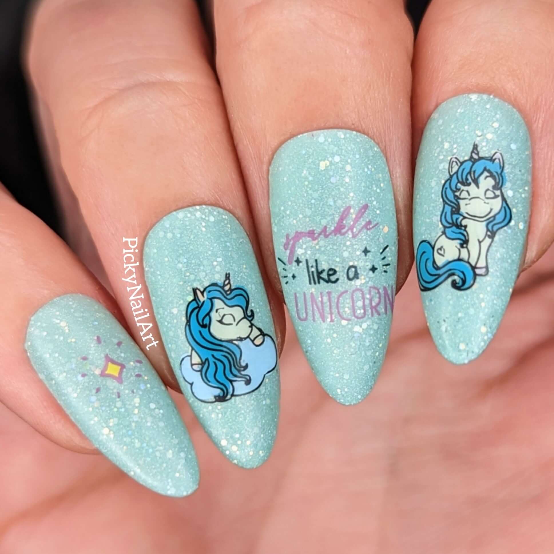 shimmering-blue-manicure-with-cute-nail-art-designs-of-unicorns-and-the-words-sparkle-like-a-unicorn