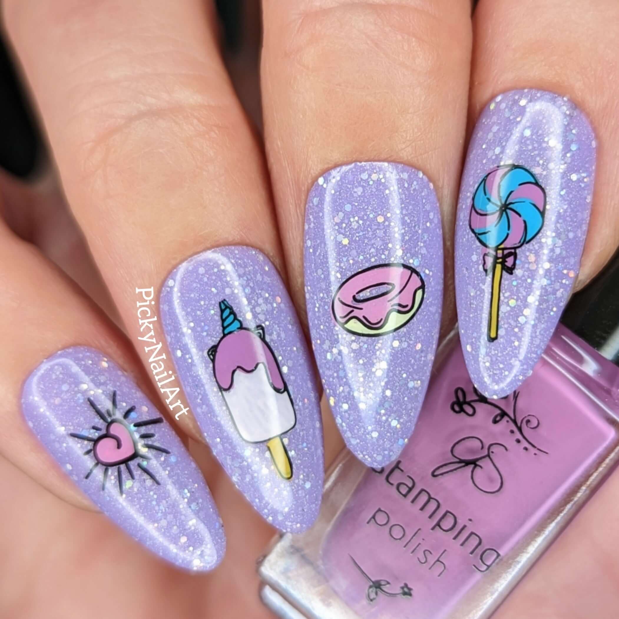 beautiful-manicure-showing-nail-art-designs-of-a-lollipop-doughnut-and-unicorn-lolly