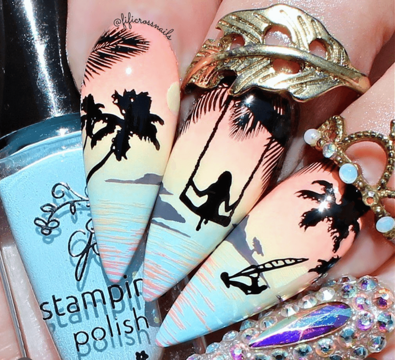 gorgeous-nail-art-design-showing-a-silhouette-of-a-girl-swinging-in-a-palm-tree-