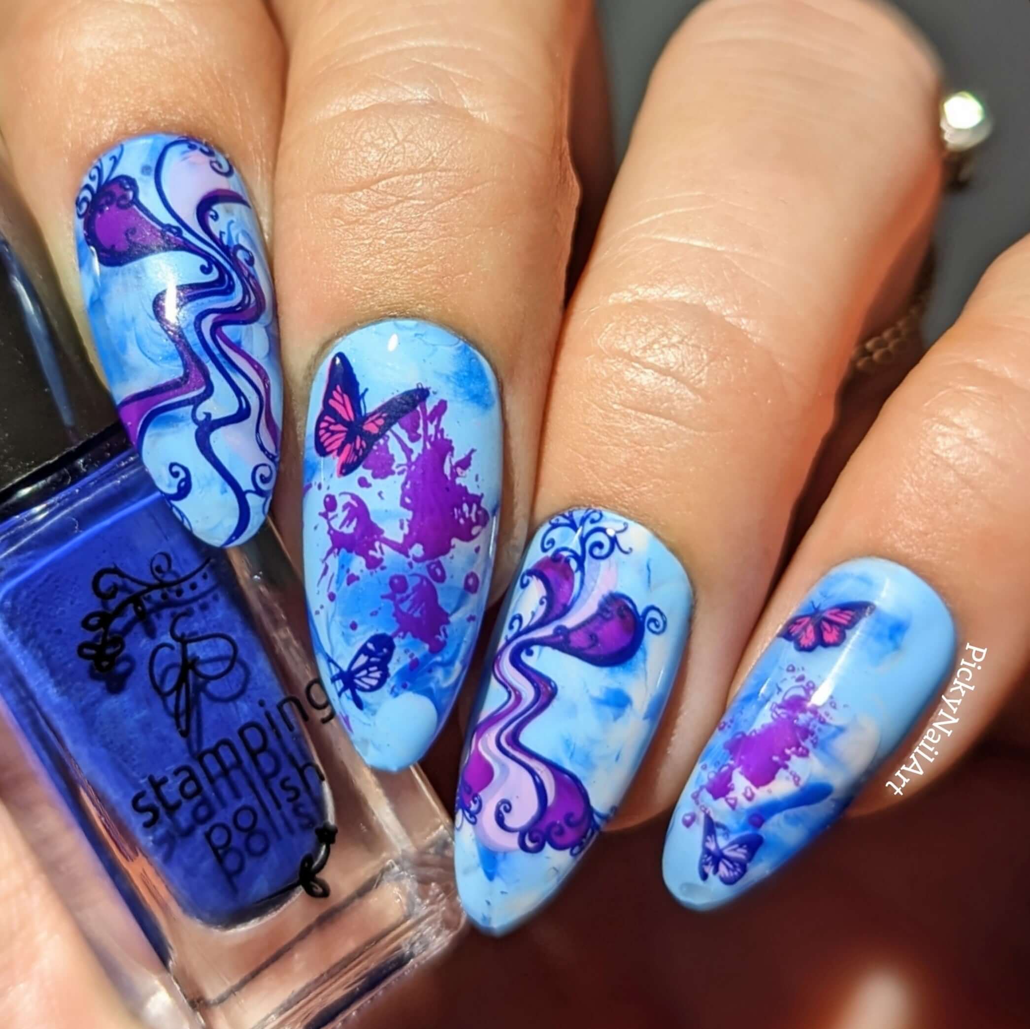 bold-blue-manicure-with-nail-art-designs-of-waves-and-butterflies