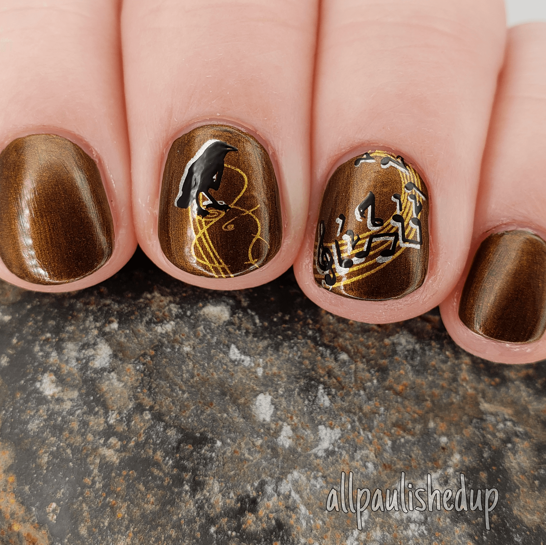 manicured-nails-showing-nail-art-designs-musical-script-and-a-crow