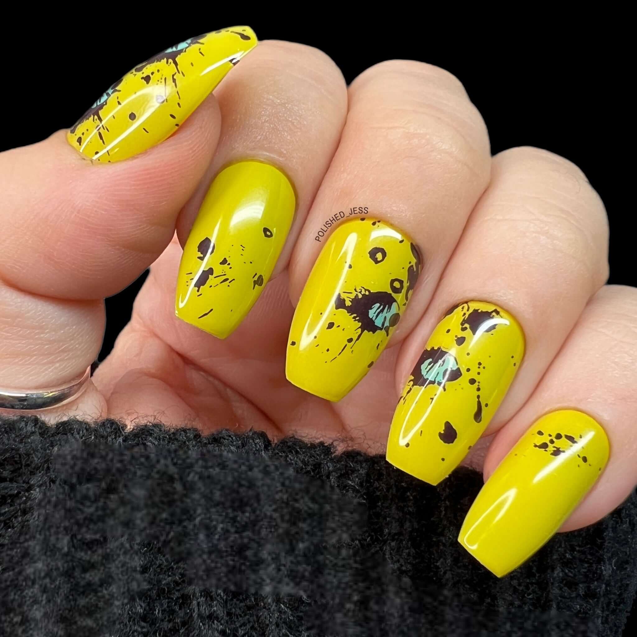 Bright-yellow-manicure-with-abstract-nail-art-designs-of-splats