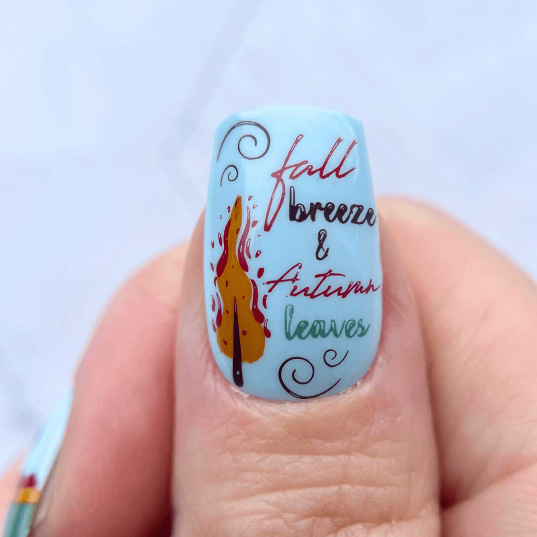 nail-art-design-showing-one-nail-with-fall-breeze-and-autumn-leaves-words-and-a-photo-of-a-tree