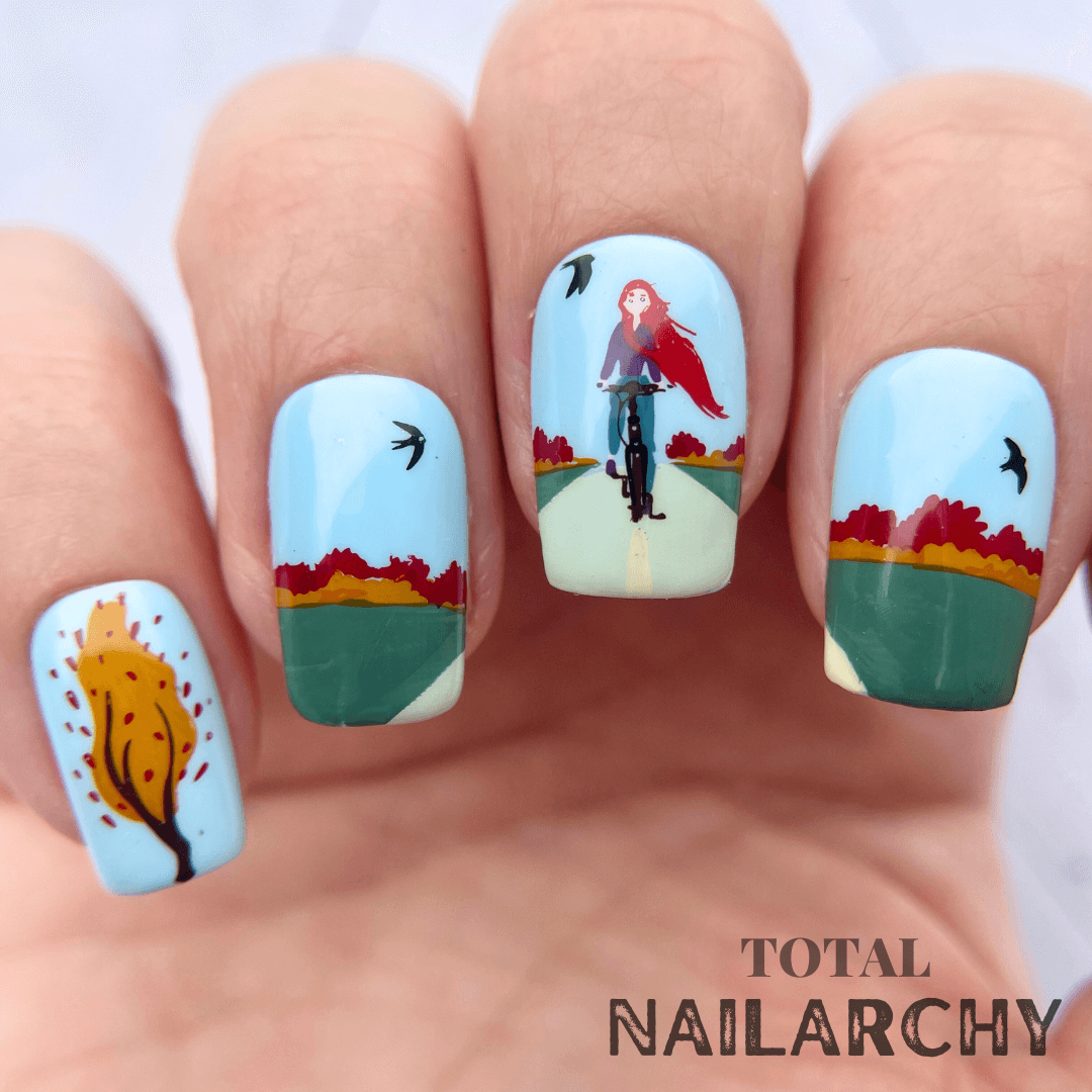 gorgeous-manicure-of-a-girl-riding-a-bike-in-the-fall-weather-and-birds-in-the-sky