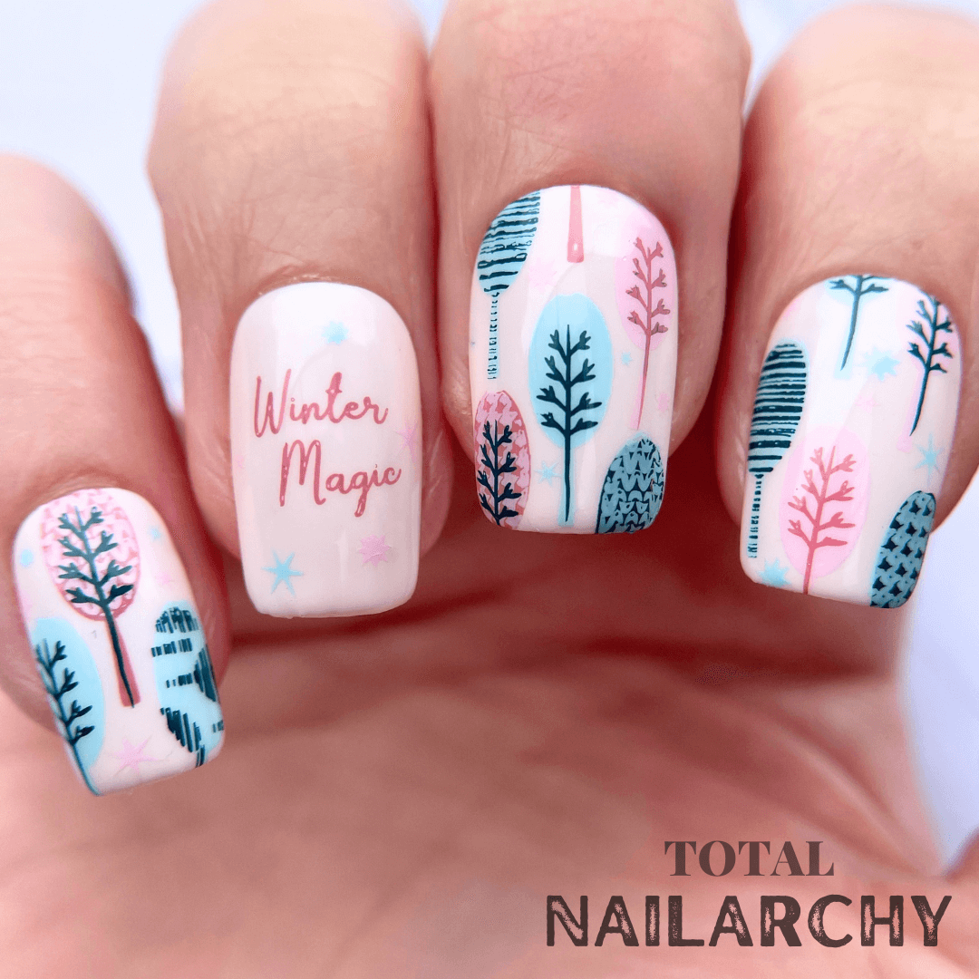 beautiful-manicure-showing-nail-art-of-winter-trees-and-words-winter-magic