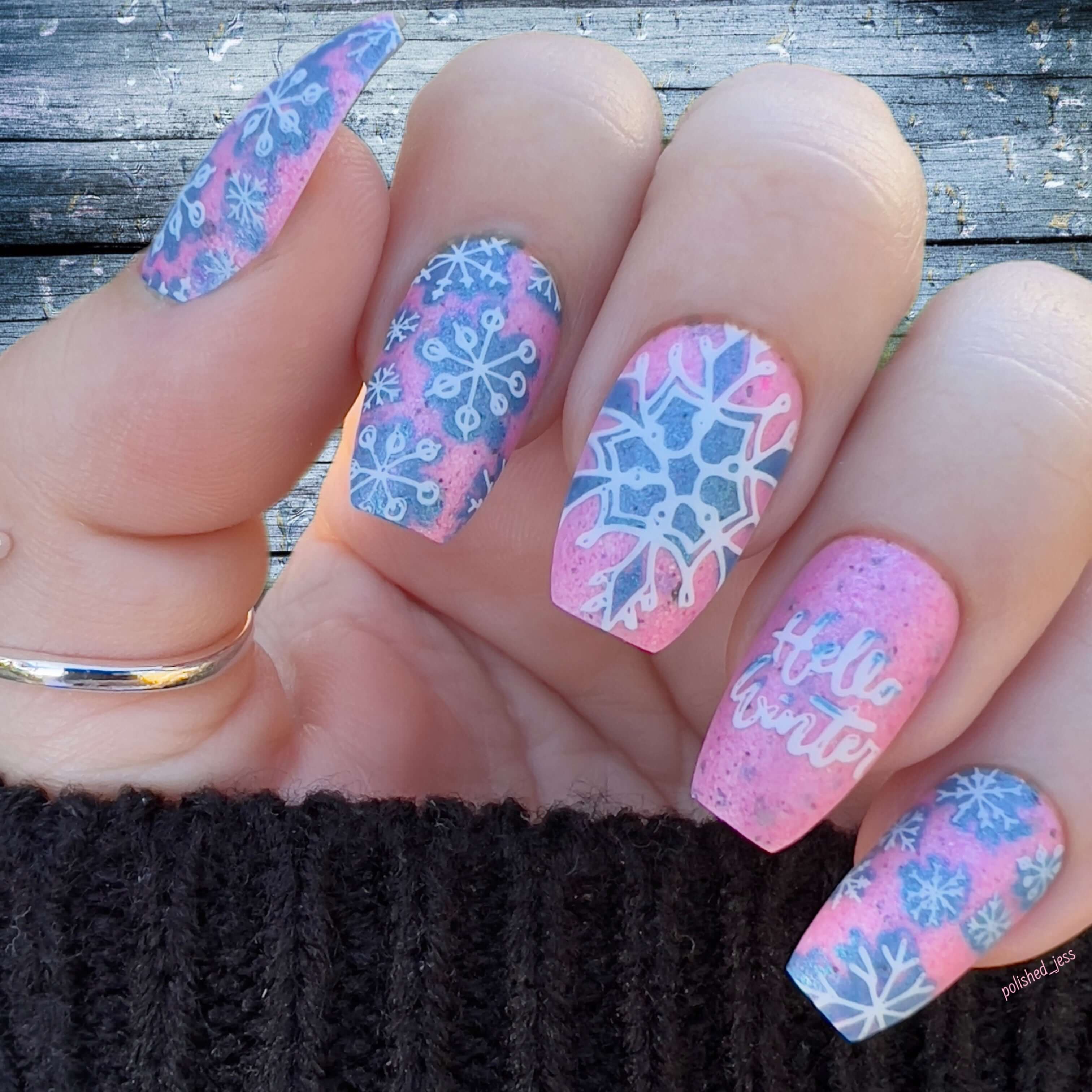 stunning-manicure-showing-nail-art-designs-of-snowflakes-and-the-words-hello-winter