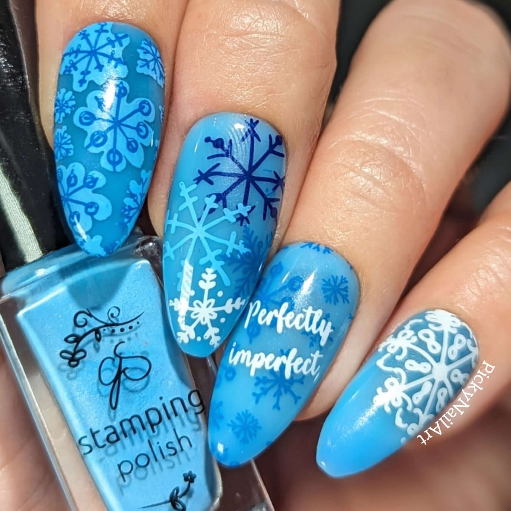 beautiful-manicure-showing-nail-art-designs-of-snowflakes-and-the-words-perfectly-imperfect