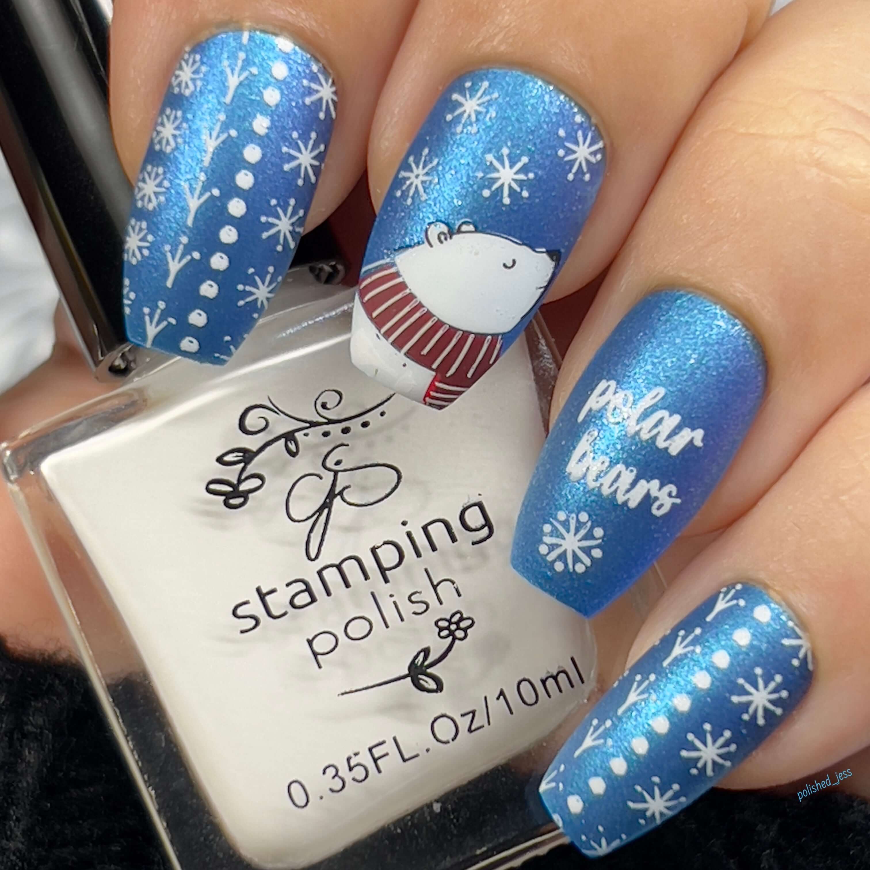 shimmery-blue-manicure-showing-nail-art-design-of-a-polar-bear-and-snowflakes