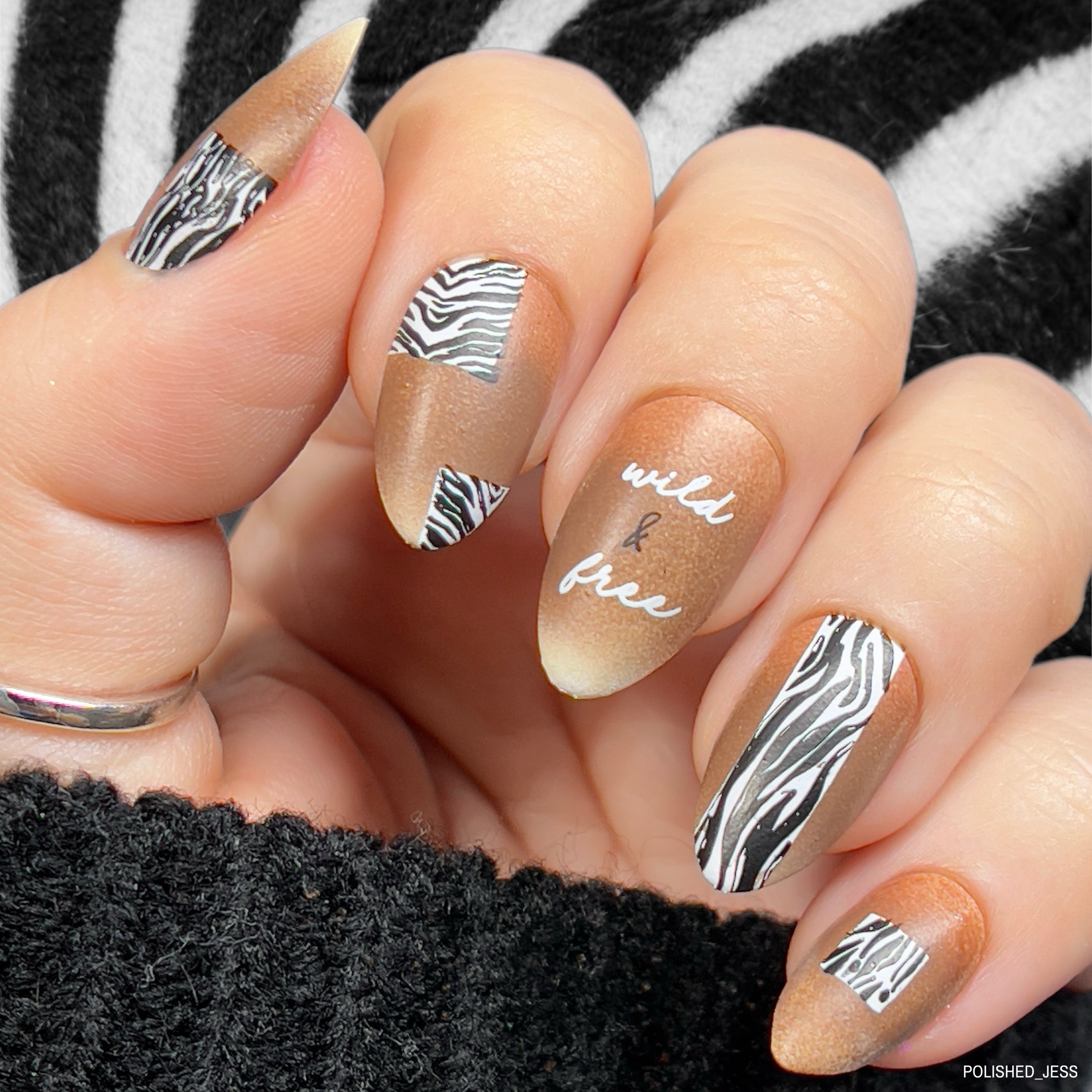 Beautiful-manicure-showing-nail-art-designs-of-zebra-print-patches-and-the-words-wild-and-free