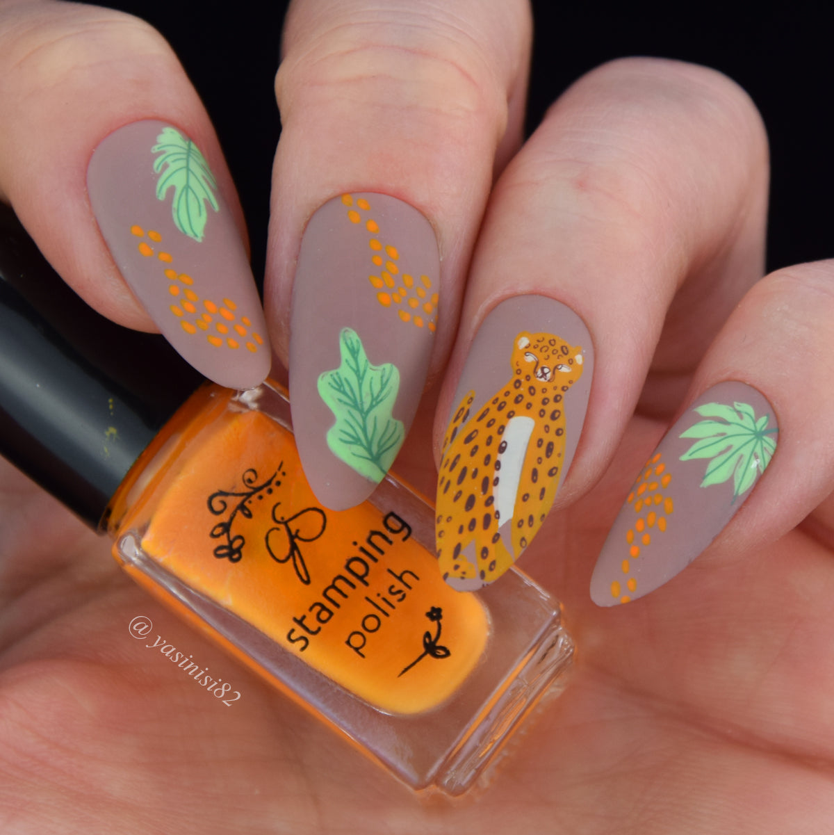 manicure-showing-nail-art-designs-of-a-cheetah-and-tropical-leaves