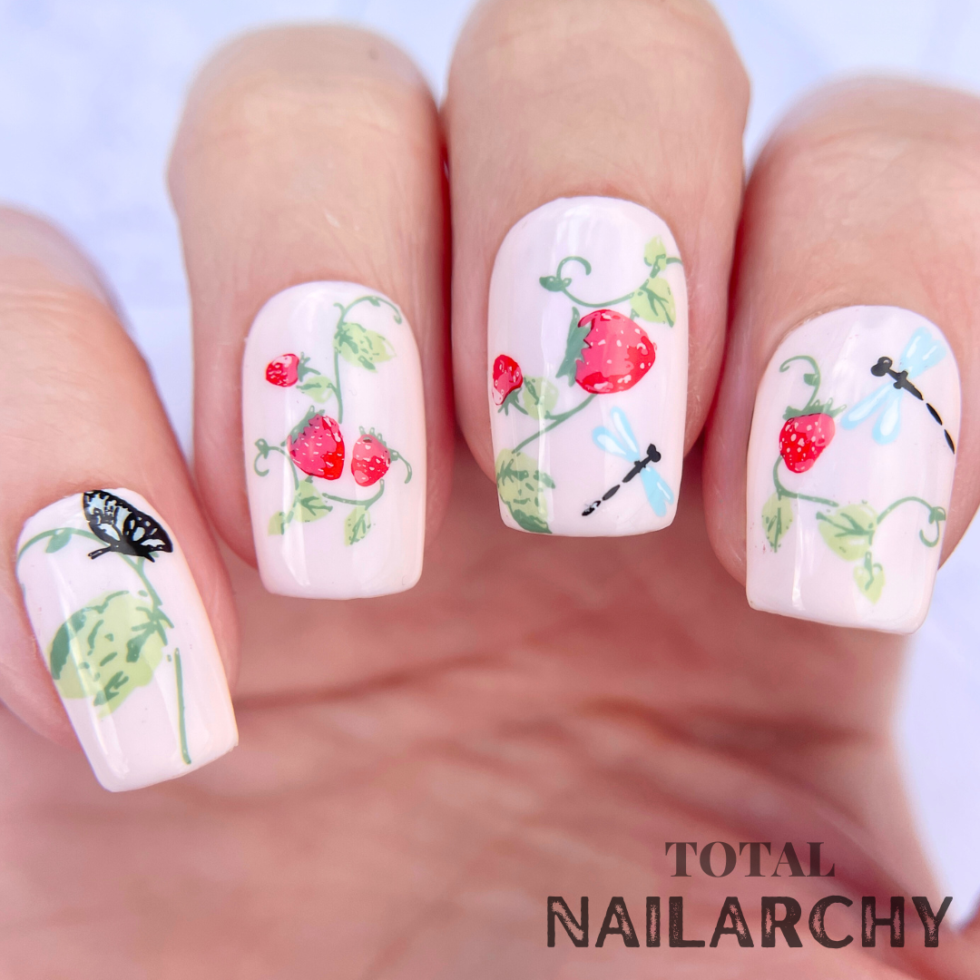 Beautiful-manicure-showing-nail-art-designs-of-strawberry-plants-with-dragon-flies-and-a-butterfly