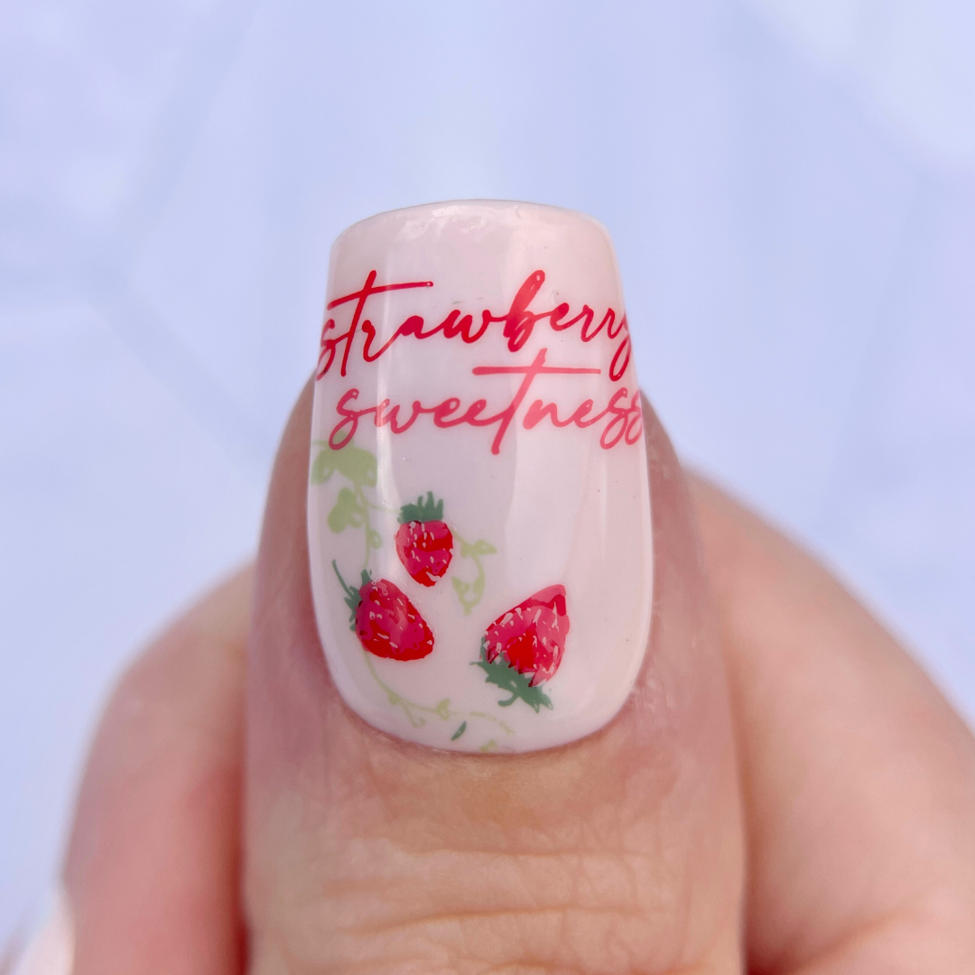 Single-manicure-nail-showing-a-nail-art-design-of-little-strawberries-with-words-strawberry-sweetness