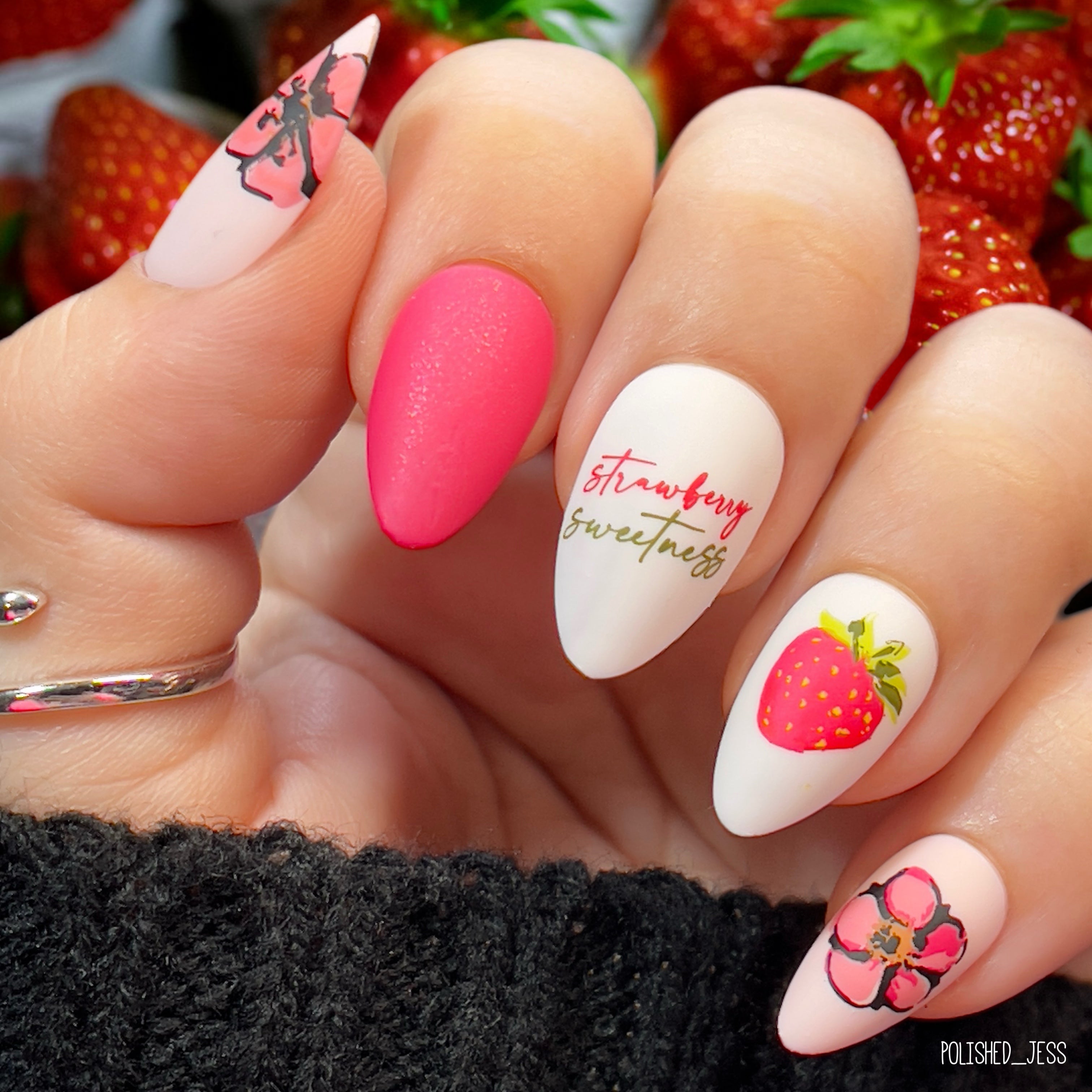 Bright-red-and-white-manicure-showing-nail-art-designs-of-a-strawberry-with-words-strawberry-sweetness