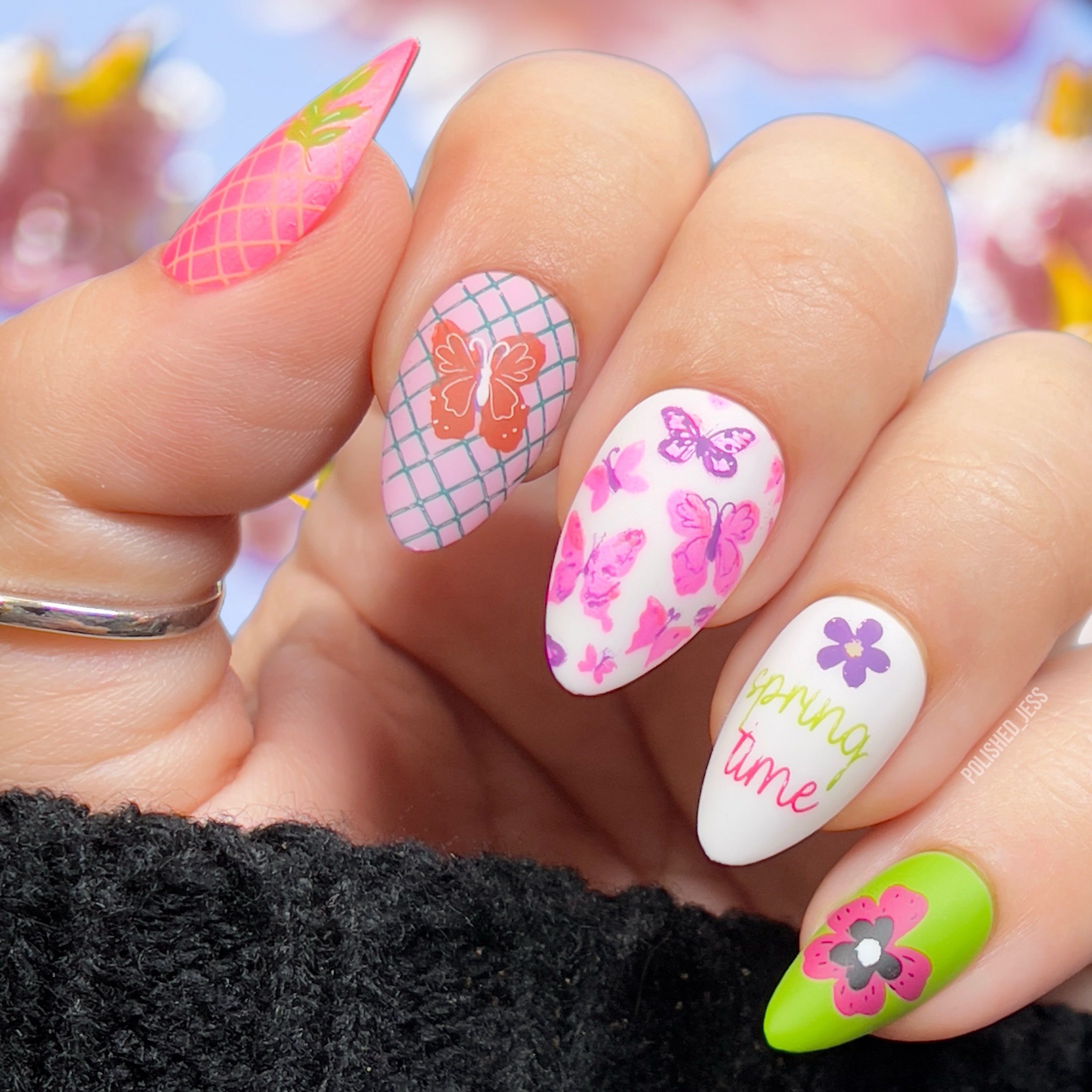 manicure-showing-modern-nail-art-designs-of-flowers-and-butterflies-with-the-words-spring-time