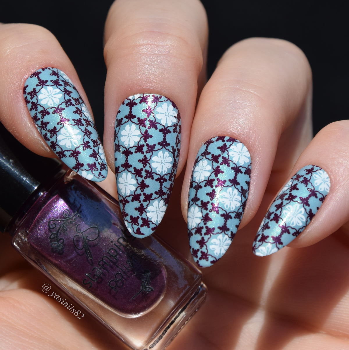 stunning-manicure-with-light-blue-polish-and-purple-and-white-floral-designs