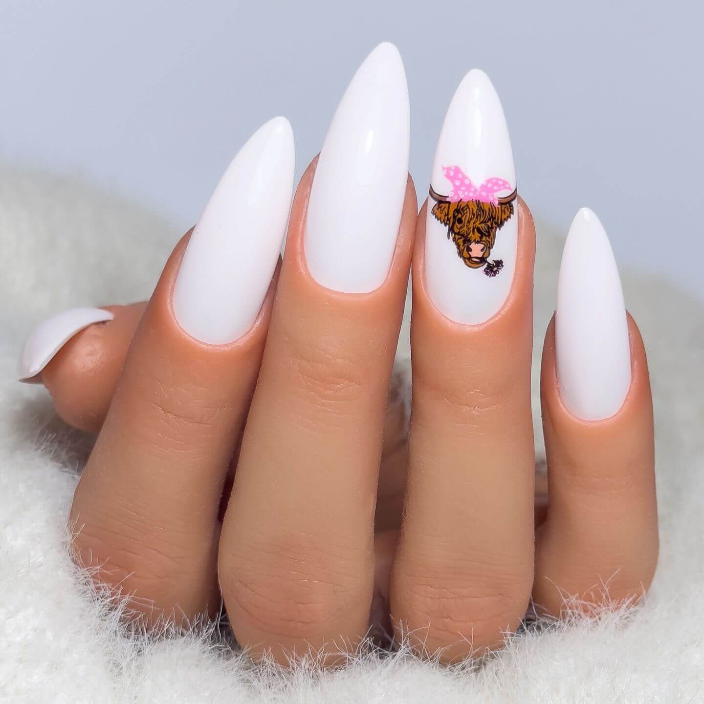 manciure-showing-nail-art-design-of-a-highland-cow-with-a-pink-bow