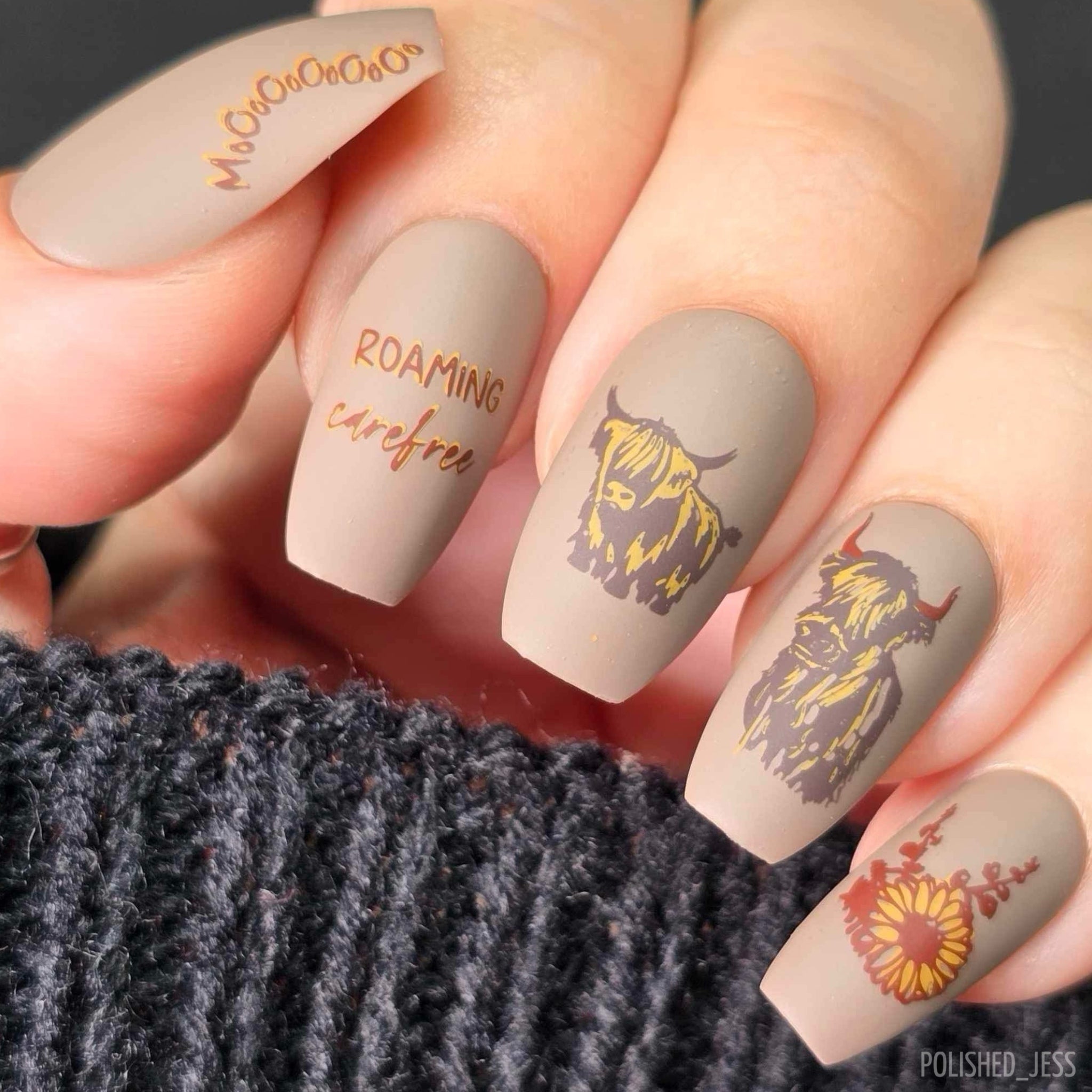 stunning-manicure-with-nail-art-designs-of-highland-cows-and-the-words-roam-carefree