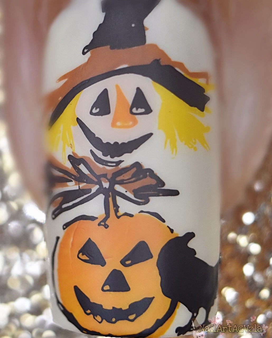 close-up-of-a-single-manicured-nail-with-gorgeous-nail-ar-tdesigns-of-a-scarecrows-face-pumpkin-and-a-black-crow