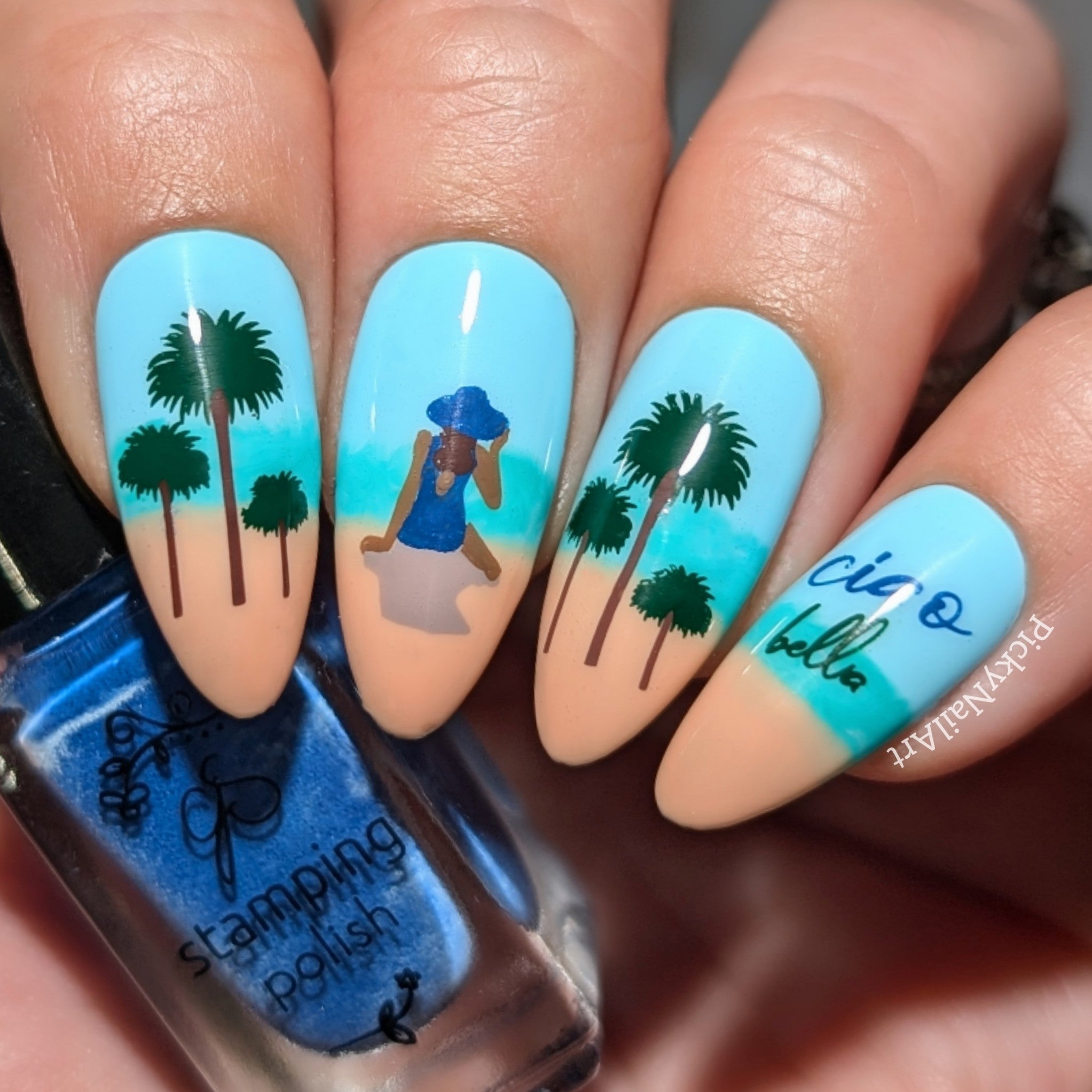 beautiful-manicure-showing-a-nail-art-design-over-four-nails-of-a-girl-sitting-on-a-beach -with-trees