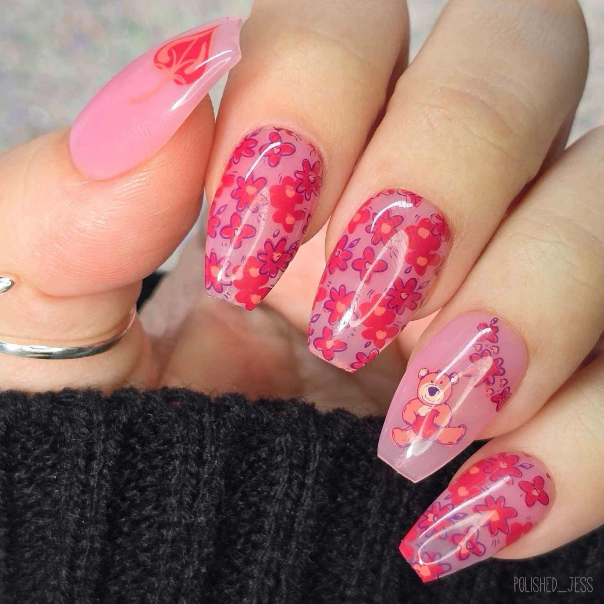 bright-manicure-with-full-coverage-floral-nail-art-pattern-and-a-teddy-bear-holding-a-heart