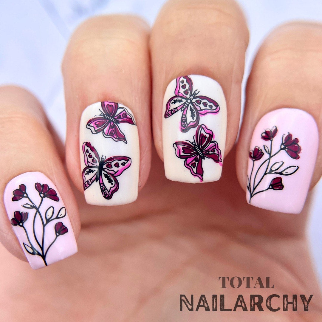 manicured-hand-with-stunning-nail-art-designs-of-butterflies-and-flowers