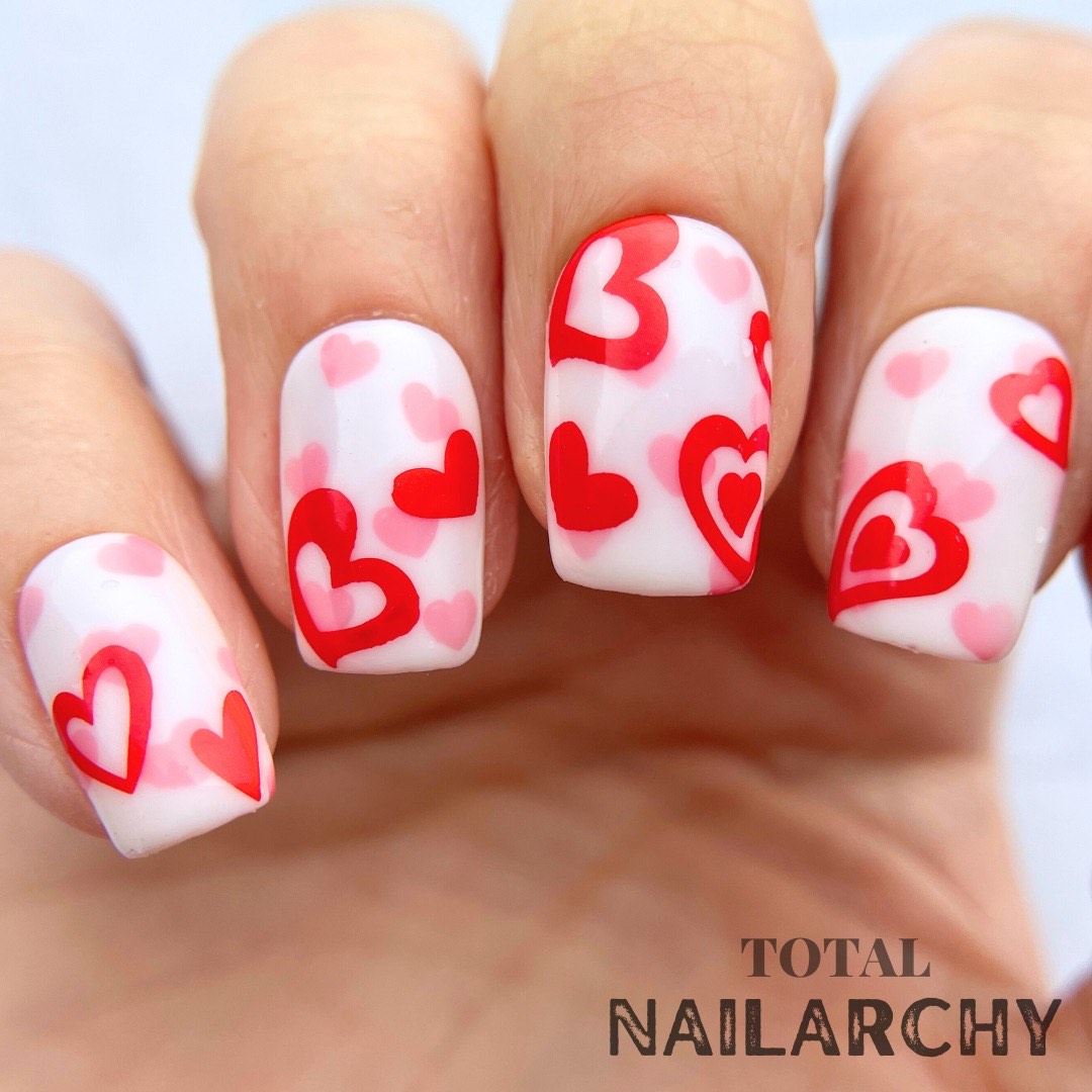 manicured-hand-with-stunning-valentines-nail-art-designs-of-hearts-in-different-patterns-and-sizes