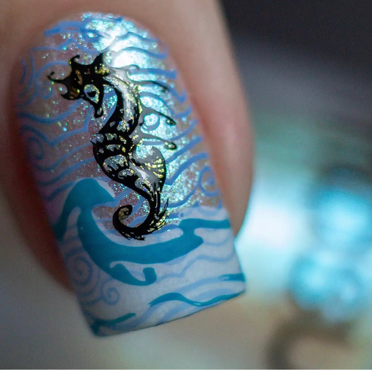 Single-manicured-nail-with-nail-art-designs-of-waves-and-a-sea-horse