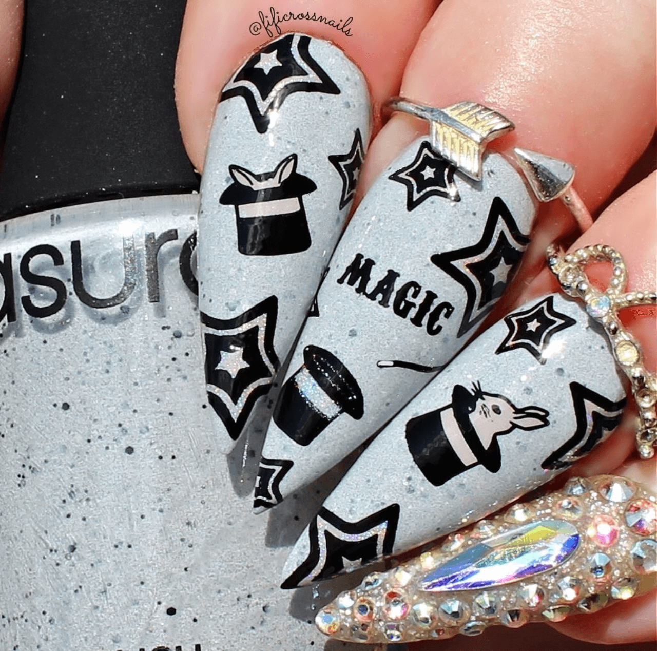 bold-manicure-with-nail-art-designs-of-stars-rabbits-in-black-hats-and-the -word-magic