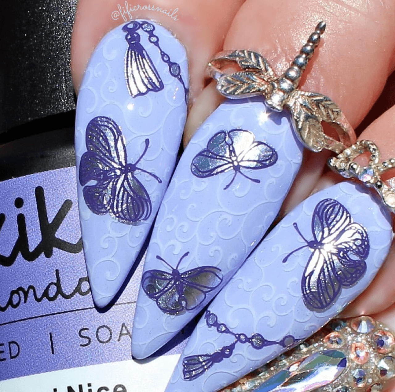 Manicure-with-layered-nail-art-designs-of-swirls-tassels-and-shimmery-butterflies