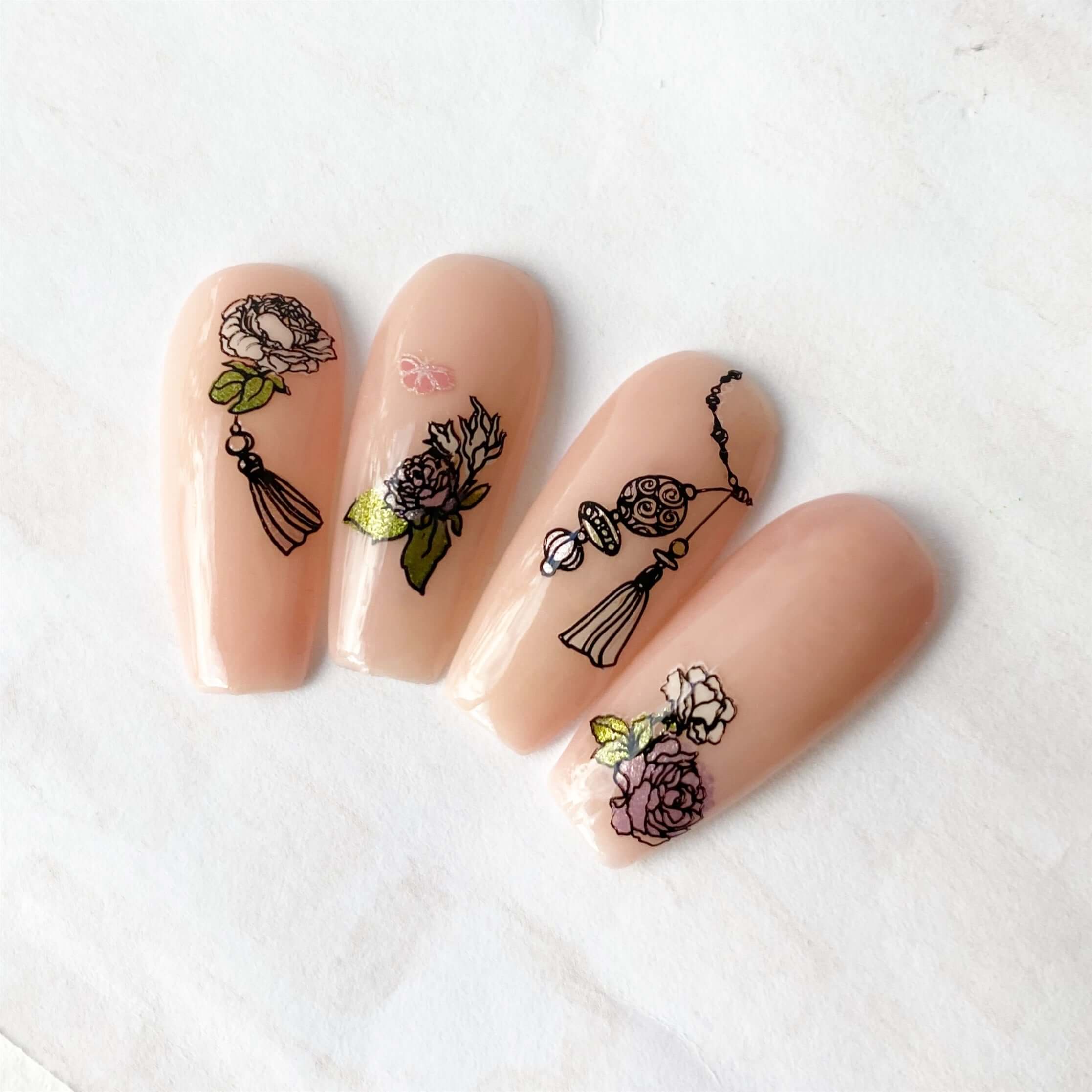 set-of-nail-tips-with-stunning-nail-art-designs-of-roses-a-butterfly-and-dainty-tassels