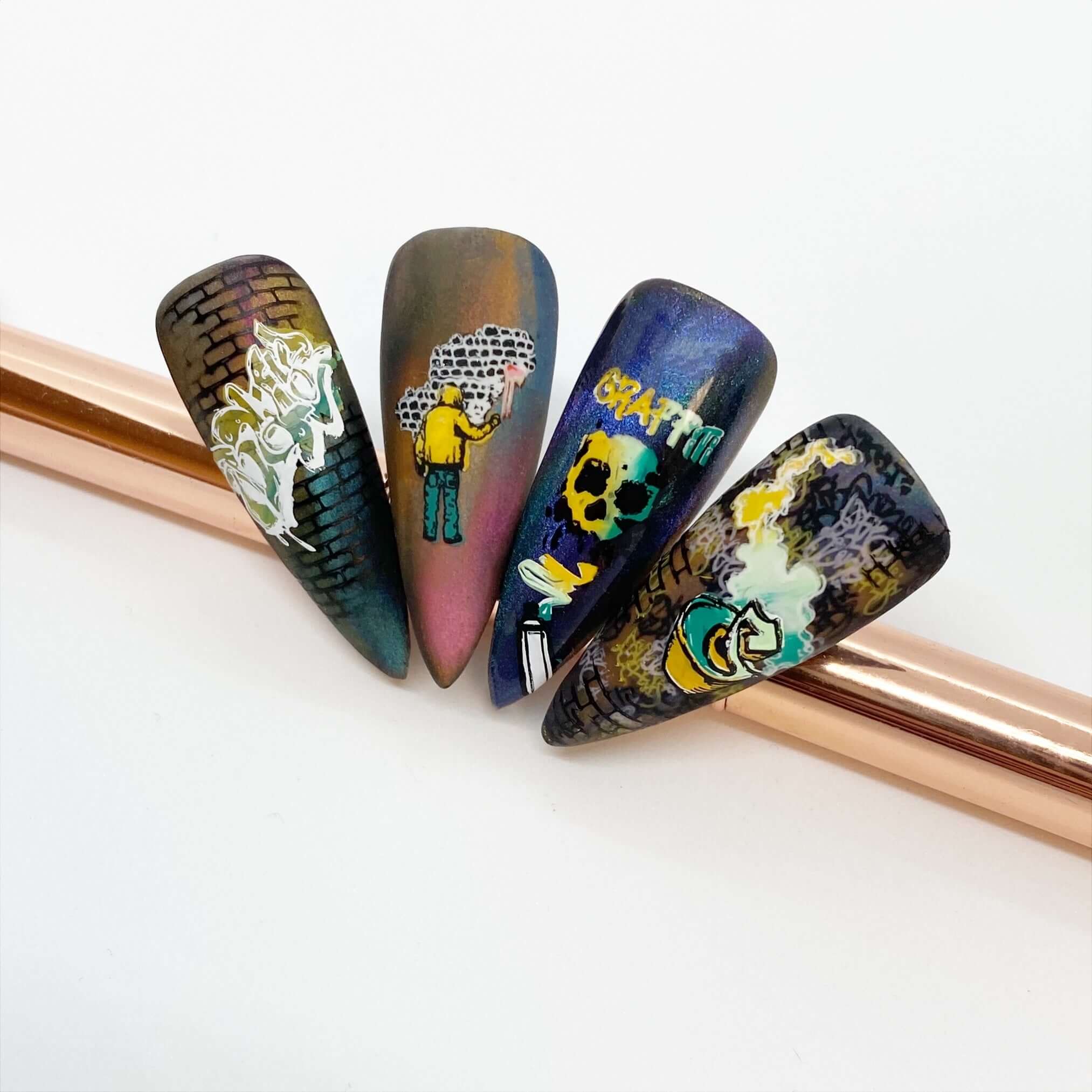 four-nail-tips-showing-a-stunning-graffti-style-layered-nail-art-design