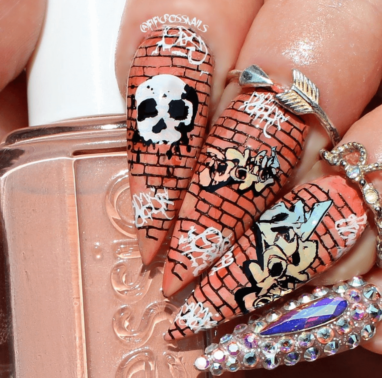 beautiful-manicure-with-nail-art-designs-of-a-brickwall-with-graffiti-style-skull-and-words