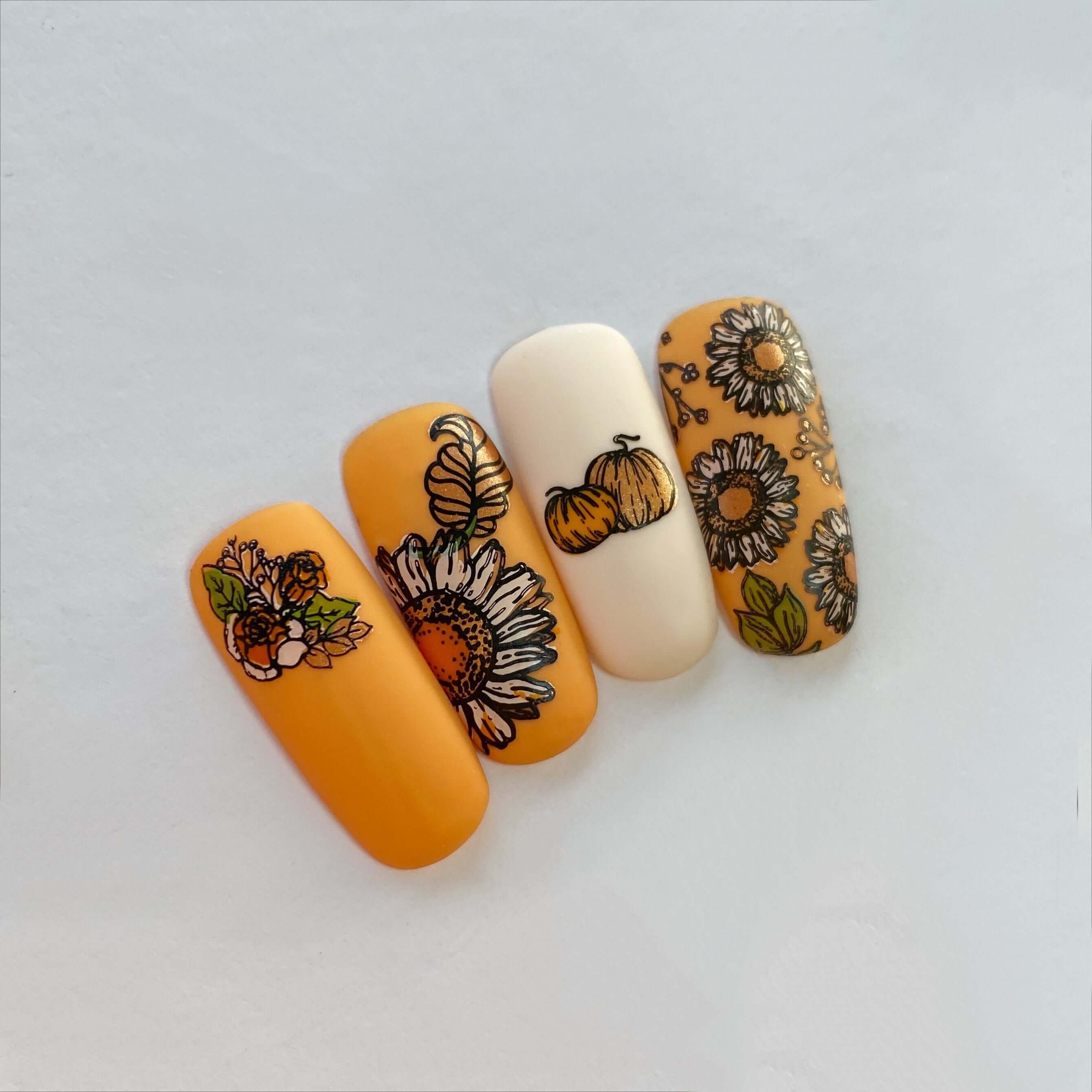 four-nail-tips-with-beautiful-nail-art-designs-of-sunflowers-and-pumpkins