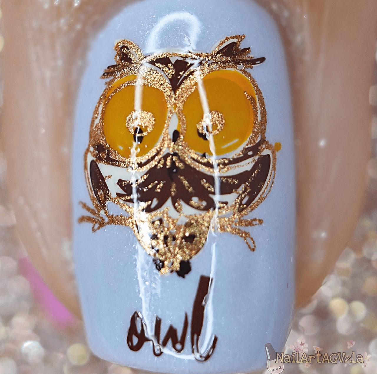 single-nail-showing-a-stamping-art-design-of-an-owl-using-shimmer-polish