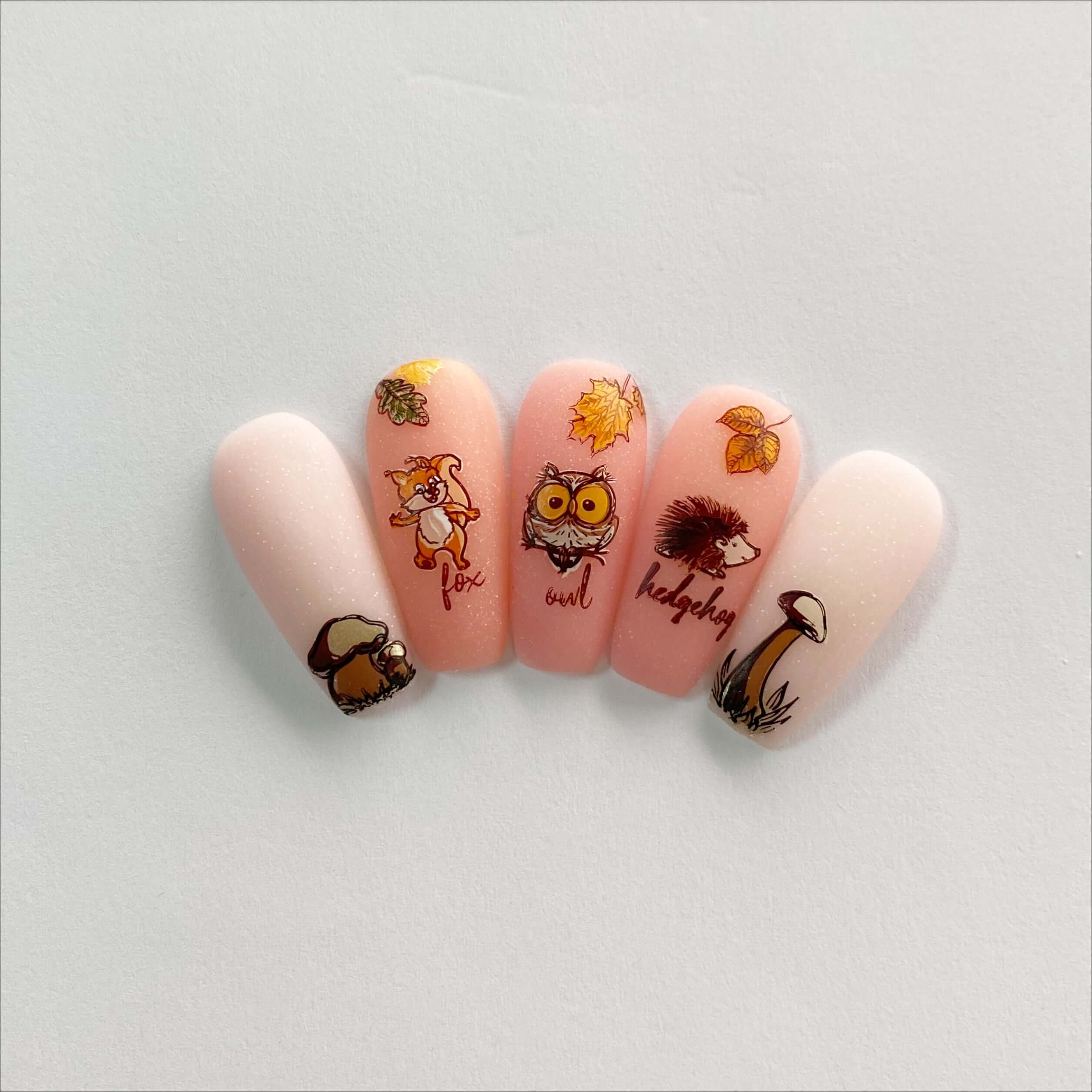 set-of-five-nail-tips-showing-a-fall-nail-art-design-of-an-owl-hedgehog-fox-and-some-mushrooms