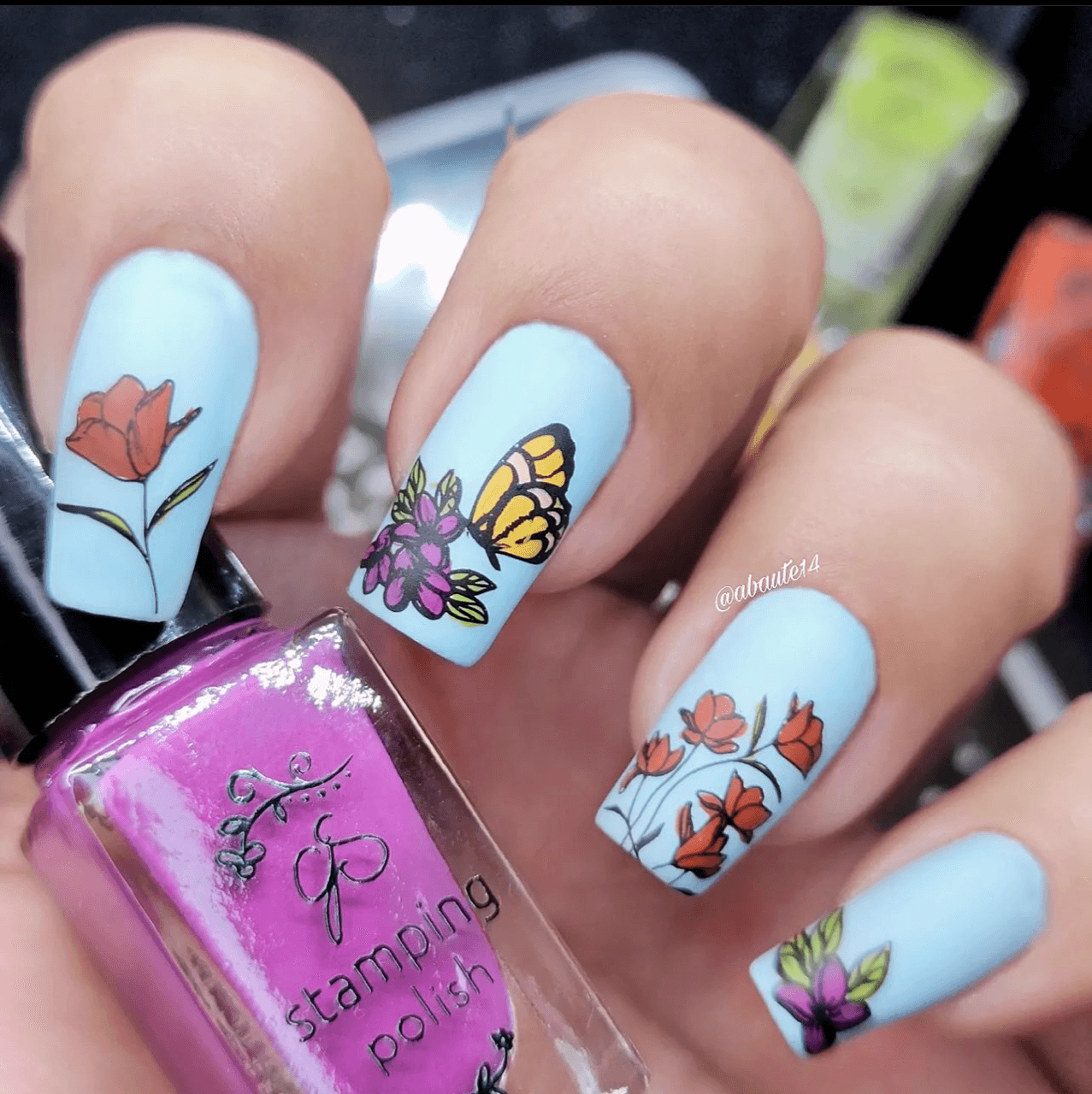 gorgeous-manicure-showing-layered-nail-art-designs-of-a-butterfly-on-some-flowers