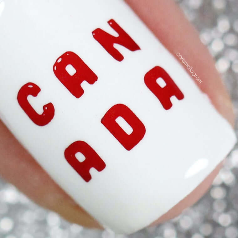 single-white-manicured-nail-showing-the-words-can-ada-in-red-nail-art