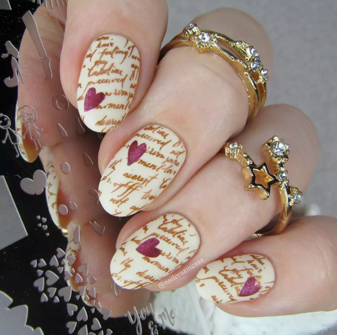 manicured-hand-with-nail-art-designs-of-script-and-hearts