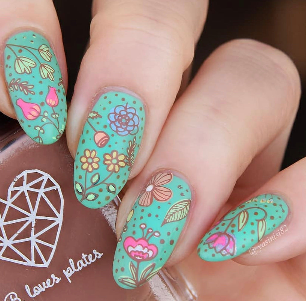 bright-manicure-showing-nail-art-designs-of-flowers-leaves-and-dot-patterns