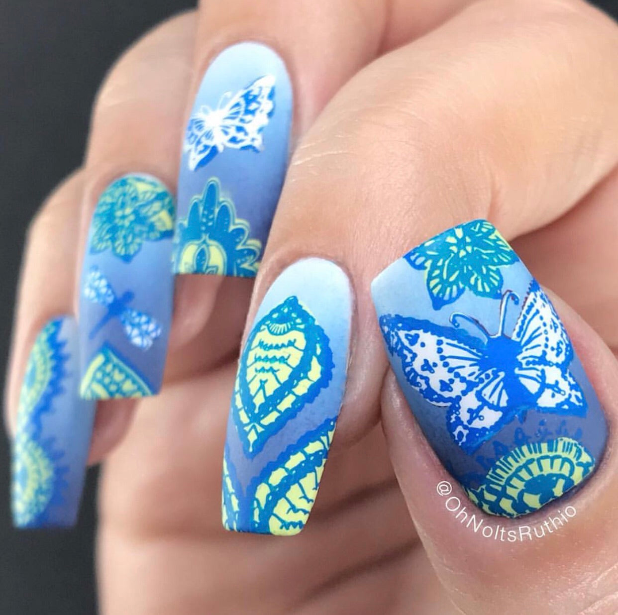 Bright-manicure-with-nail-art-designs-of-delicate-lace-butterflies